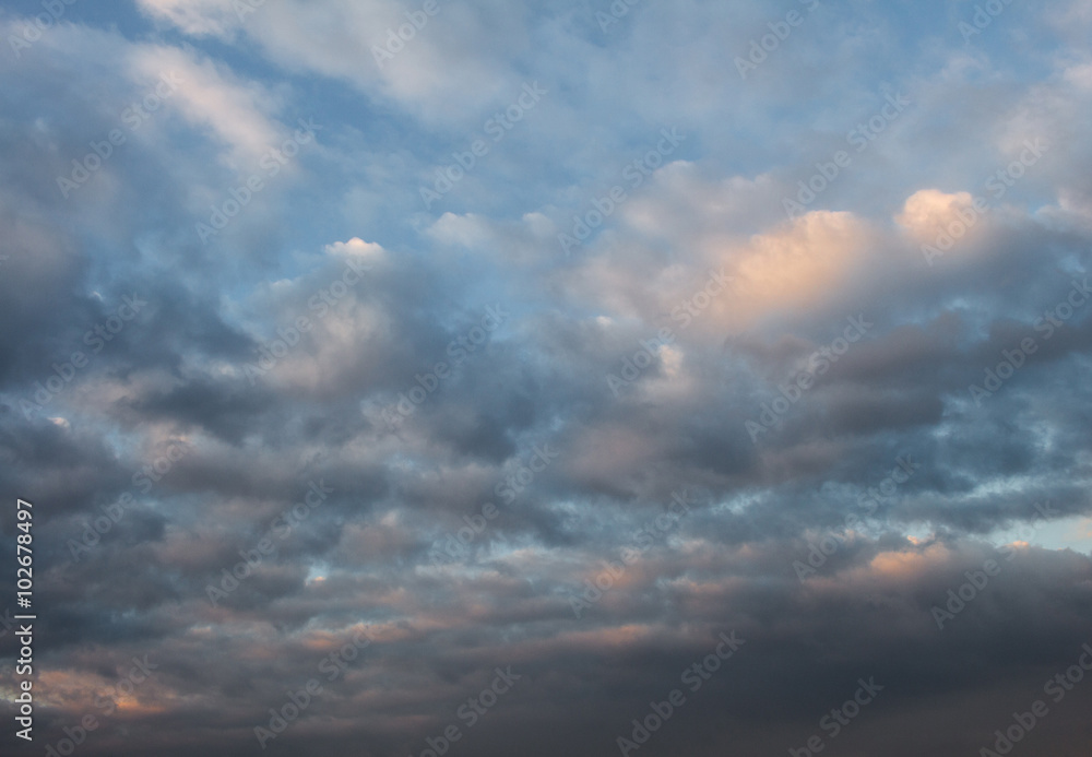 Blue, beautiful sky with  orange, grey clouds