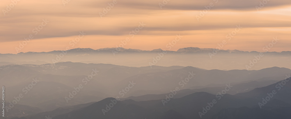 Layers of beautiful hills in the early fogy morning