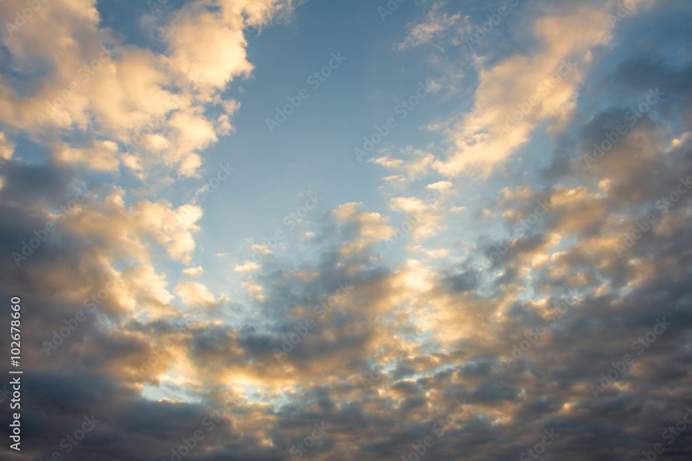 Obraz premium Blue, beautiful sky with orange, grey clouds