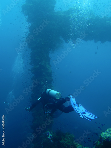 Scuba diving to ship wreck silhouette from the world war 2, Pacific Ocean