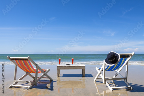 Fototapeta Naklejka Na Ścianę i Meble -  Two deckchairs on the beach for leisure during sunny day