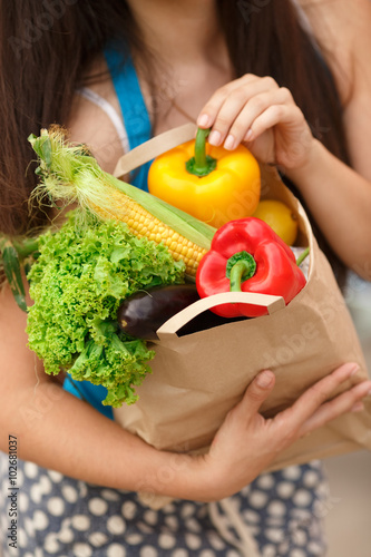 Healthy vegetables food in woman hand, girl shopping market ar supermarket  photo