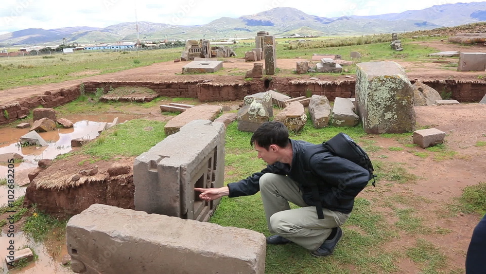 Man is looking at megalithic stones in the complex Puma Punku near Tiwanaku, Bolivia Man is looking at megalithic stones in the complex Puma Punku near Tiwanaku, Bolivia