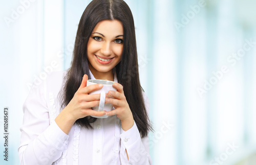 portrait of successful business woman with Cup of coffee on back