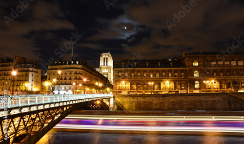 River Seine night view with Notre Dame cathedral in the background