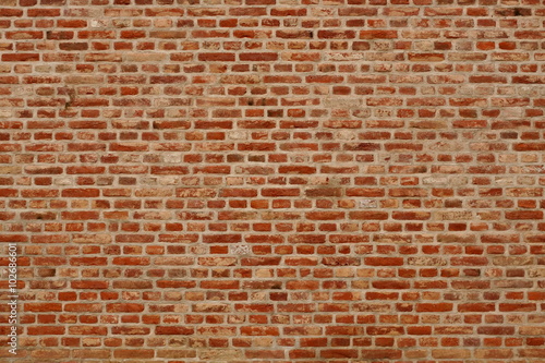 Brick wall horizontal background with red, orange and brown bricks