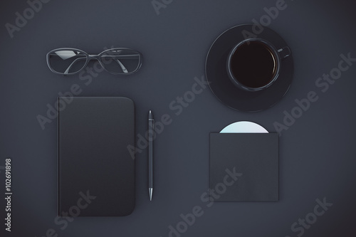 Blank black diary cover with cup of coffee, eyeglasses and CD di