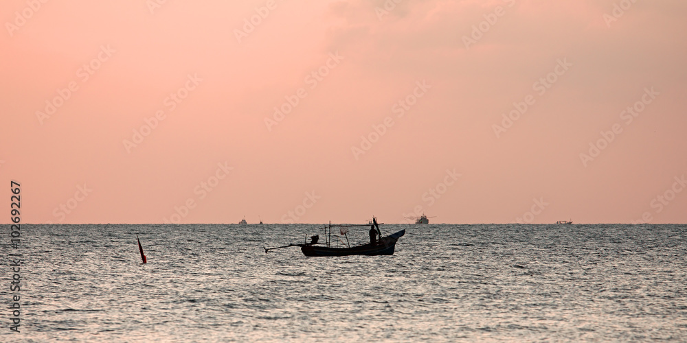 lonely fisherman's boat at sunrise