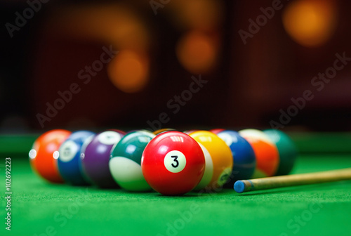 Billiard balls in a green pool table photo