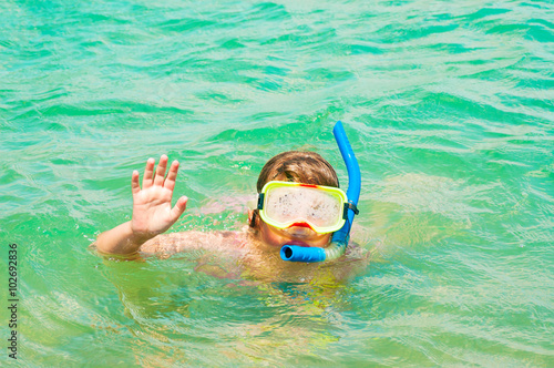 Little girl swims in sea with snorkel © unclepodger