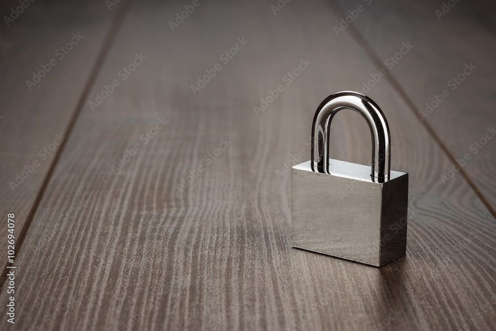 Naklejka premium check-lock on the brown wooden table background