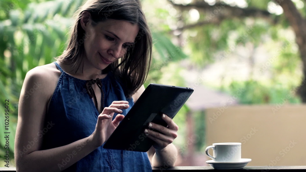 Portrait of happy, beautiful woman with tablet compute standing on balcony
Portrait of happy, beautiful woman with tablet compute standing on balcony