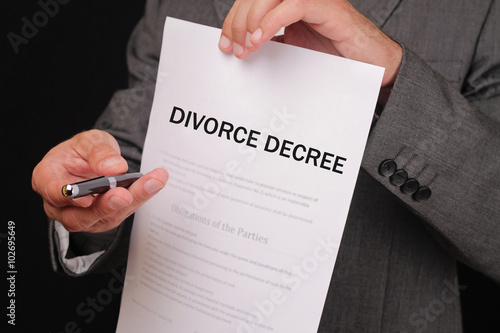 Divorce concept. Man offering a pen to sign divorce decree close up.