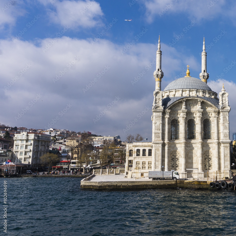 picturesque small Ortakoy mosque  on the shores of the Bosporus Strait 
