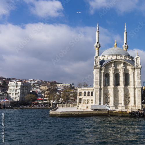 picturesque small Ortakoy mosque on the shores of the Bosporus Strait 