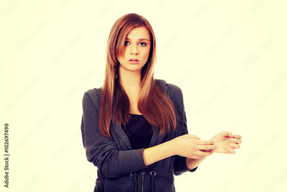 Teenage woman holding her wrist - pain concept Teenage woman holding her wrist - pain concept