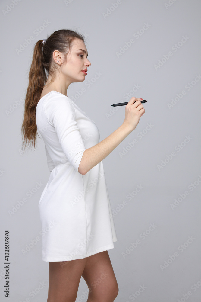 young woman with pen on grey background young woman with pen on grey background