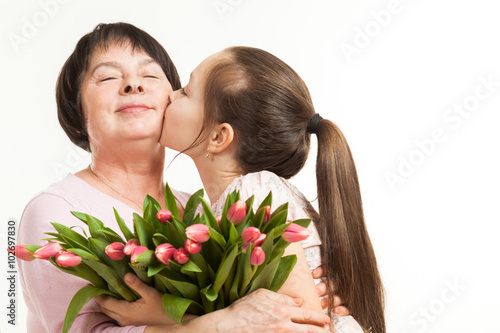 the granddaughter kisses the grandmother © Сергей Чирков