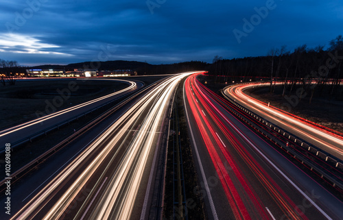 white and red car light trails on motorway junction