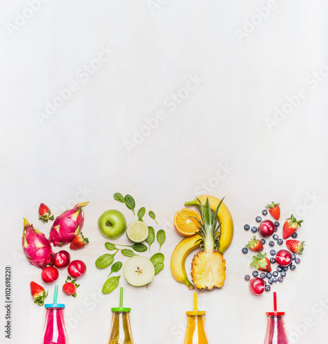 Healthy fruits smoothies with colorful ingredients  on white wooden background, top view, place for text.  Superfoods and healthy lifestyle or detox  diet food concept.