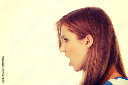 Angry young woman screaming for someone