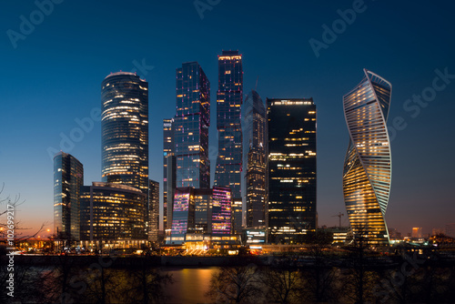 View on International Moscow City Business Center in the night from another side of the river on the embankment