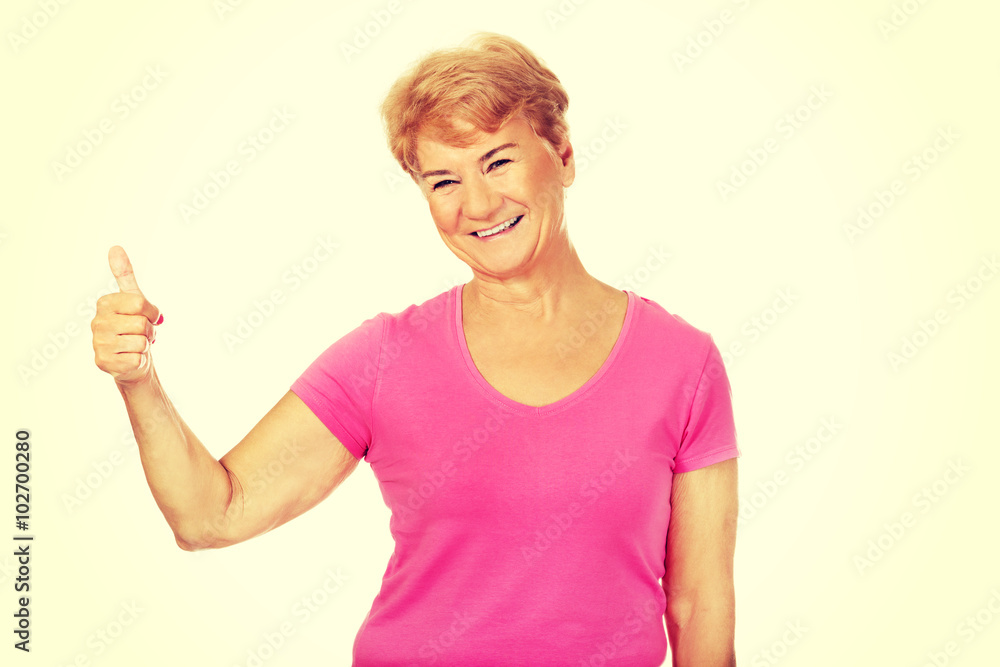 An old smilig woman with thumb up An old smilig woman with thumb up