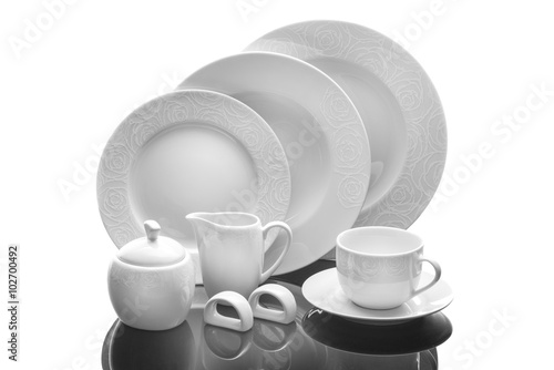 Dining porcelain set of plates, cup and napkin ring with ornament isolated on white background, product photography, serving set