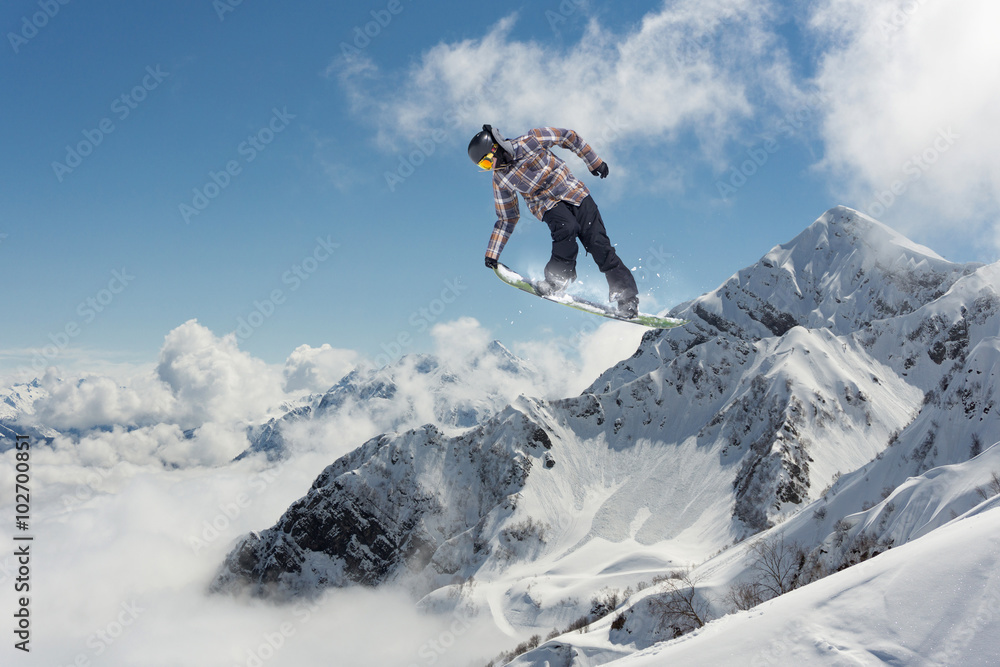 Flying snowboarder on mountains. Extreme sport. Flying snowboarder on mountains. Extreme sport.