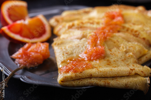 Pancakes with jam of red oranges.selective focus.