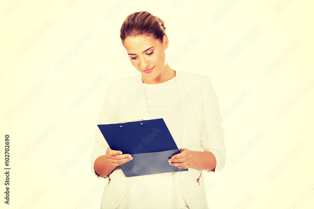 Thoughtful focused businesswoman reading her notes Thoughtful focused businesswoman reading her notes