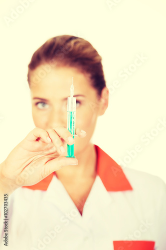 Female nurse or doctor with a syringe in hand