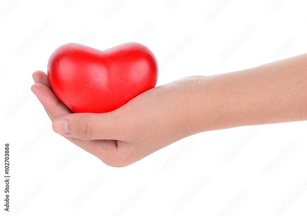 Hands holding a red heart as symbol for love and care