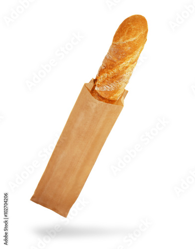Fresh Baguette in a paper bag, over the white background.