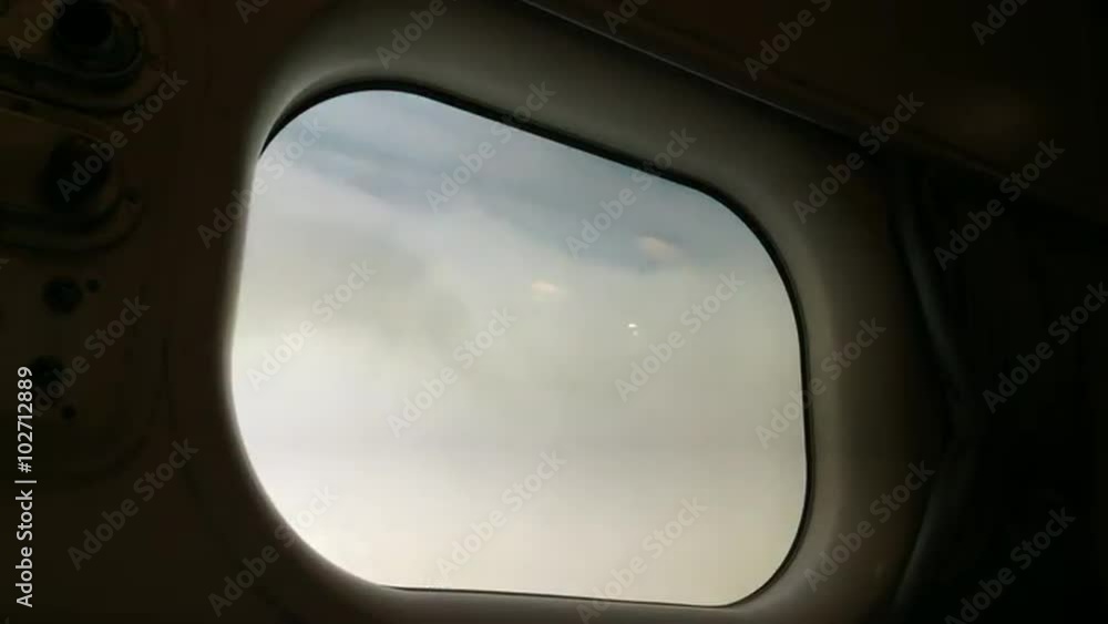 Plane window view of clouds in the sky during flight. Air transport concept Plane window view of clouds in the sky during flight. Air transport concept