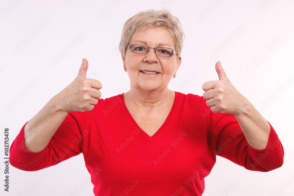 Happy smiling elderly woman showing thumbs up, positive emotions in old age Happy smiling elderly woman showing thumbs up, positive emotions in old age