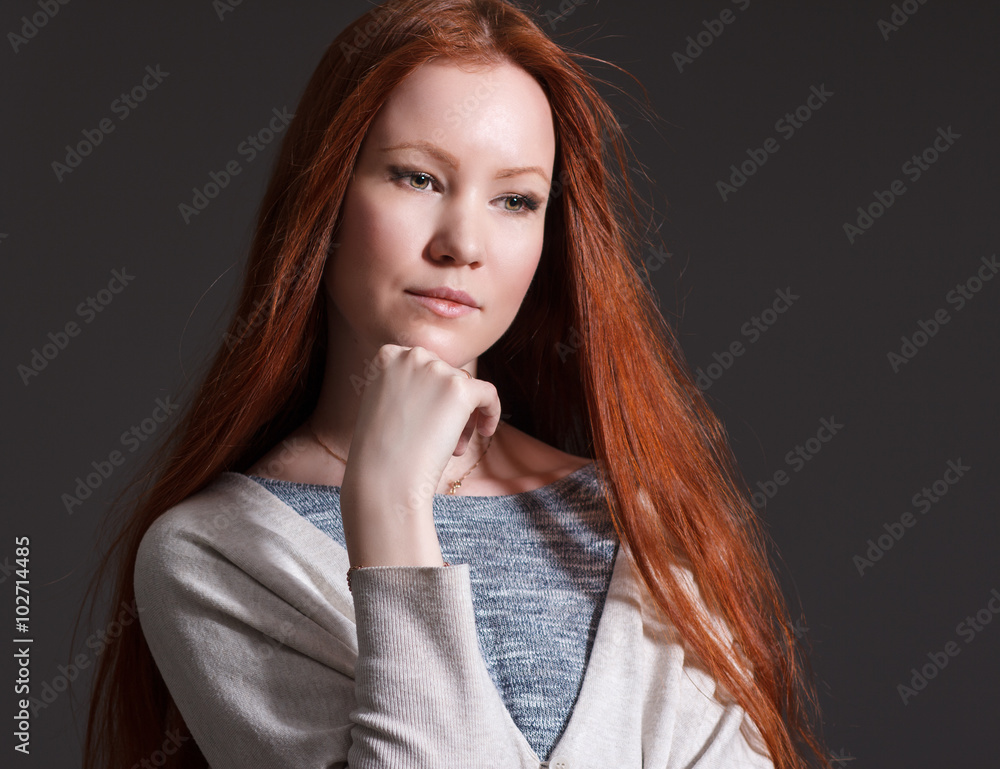 Portrait of a beautiful young woman with red long hair . Portrait of a beautiful young woman with red long hair .