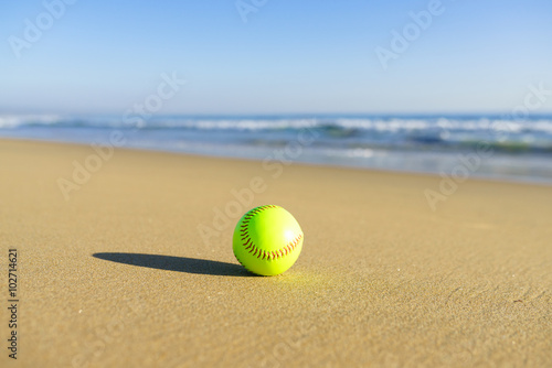 Softball at a California beach with white wave in pacific ocean