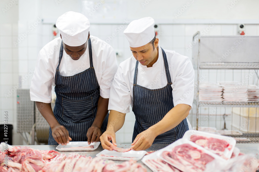 butchers packing meat pieces