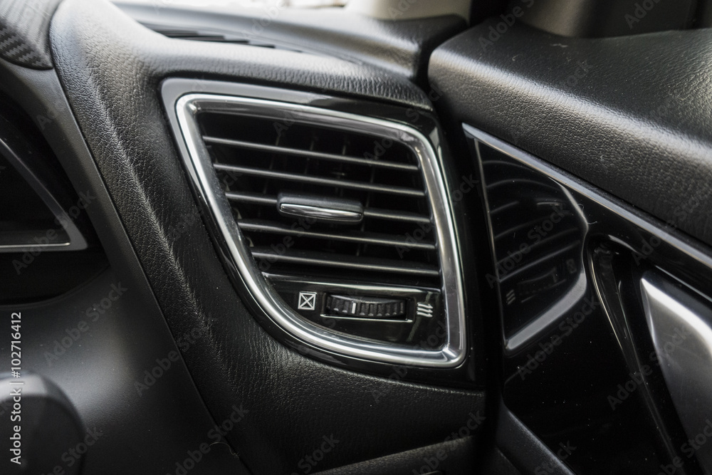 Detail with the air conditioning button inside a car.