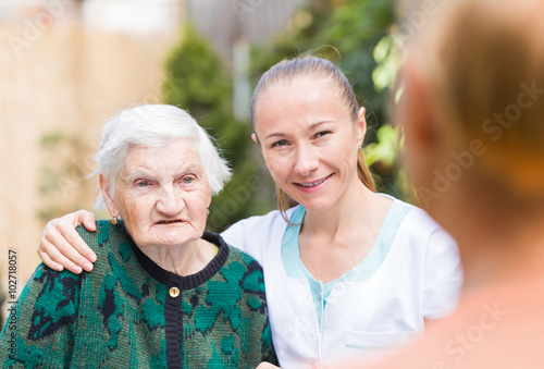 Elderly woman with caregiver
