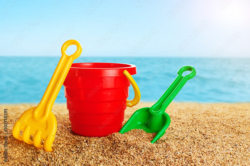 Baby toy bucket, shovel and rake in the sand. Baby toy bucket, shovel and rake in the sand.