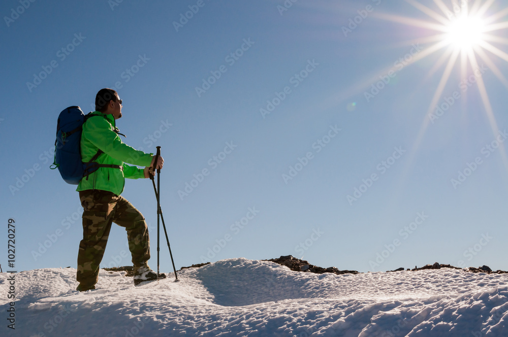Hiker relaxing on top of hill and enjoying on sunny day Hiker relaxing on top of hill and enjoying on sunny day