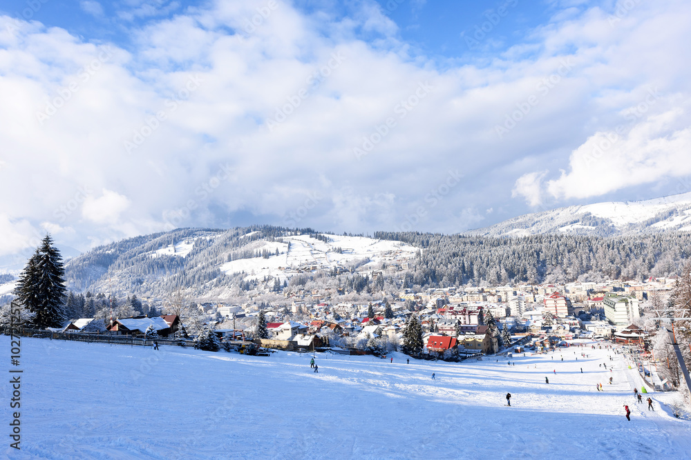 Ski slope with happy people at mountains with blue sky Ski slope with happy people at mountains with blue sky