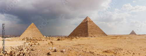 Giza pyramid complex on the background of clouds and Cairo panorama