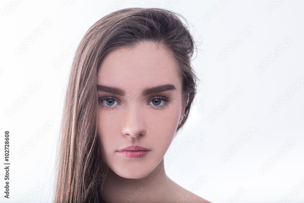 Fototapeta premium Portrait of beautiful girl with brown hair on white background