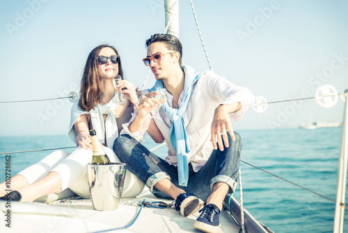 Couple drink champagne on a boat © oneinchpunch