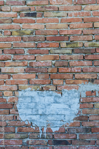 Old brick wall with a white stain useful for copyspace