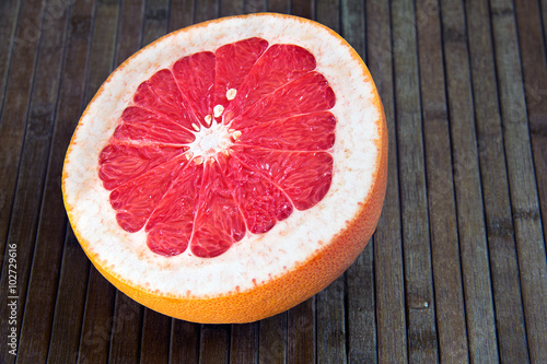 half grapefruit on a wooden background