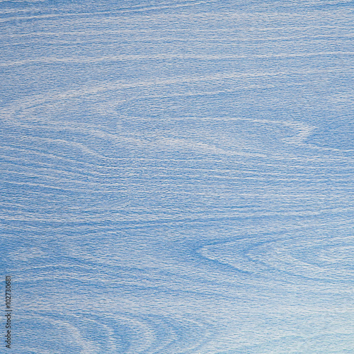 Pastel light blue background, wood grain curves and patterns.